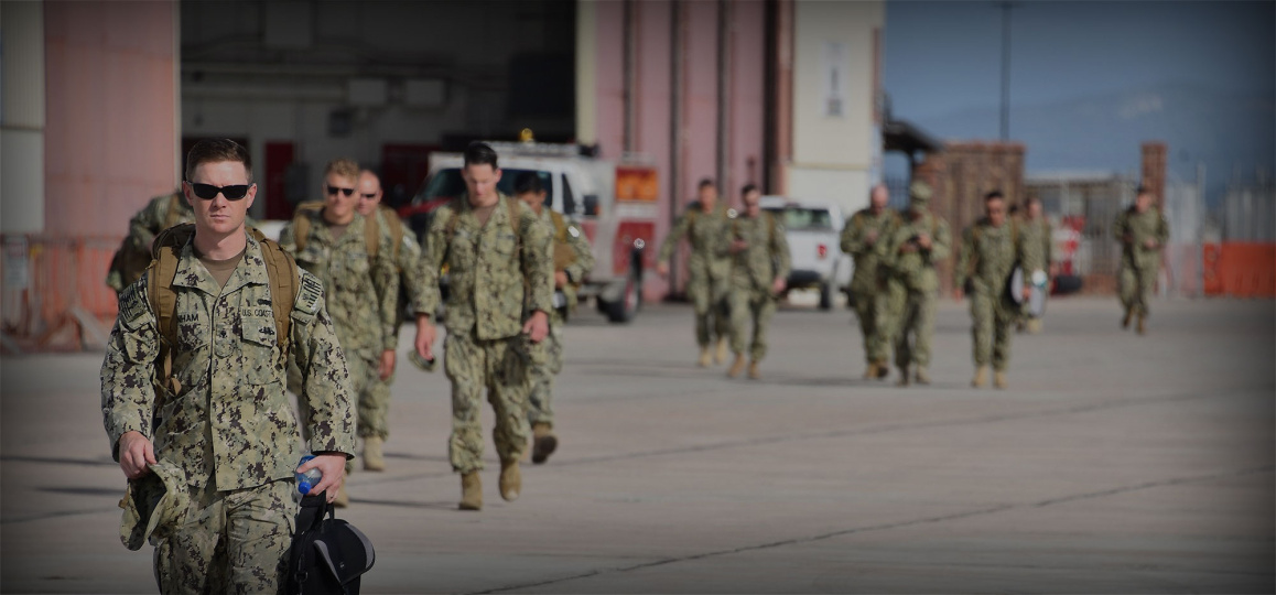 Coast Guard members walking across runway.