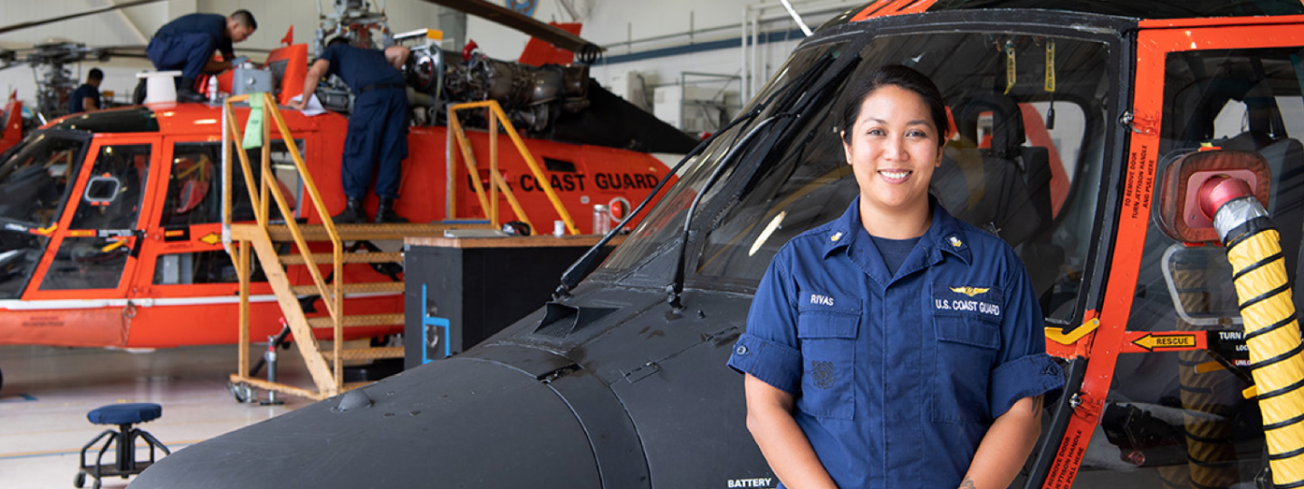 AMT standing in front of a helicopter