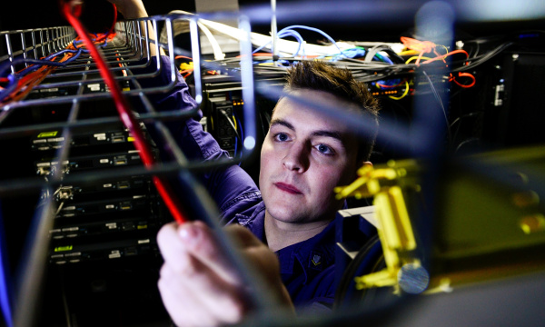 Person running cables in a server room