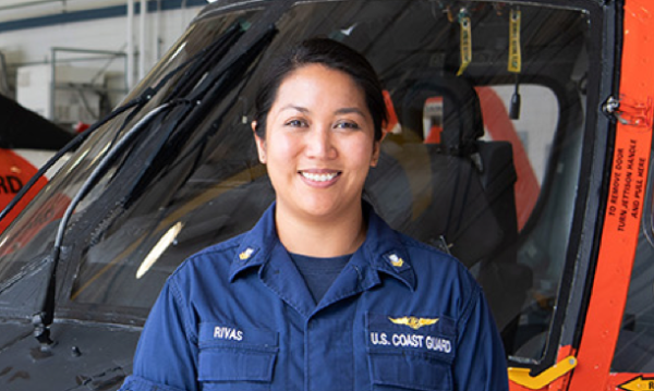 AMT standing in front of a helicopter